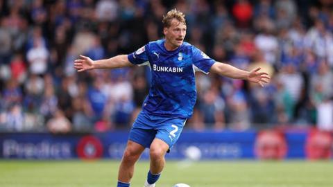 Gus Scott-Morriss of Oldham Athletic runs with the ball during a League Two match with Port Vale at Boundary Park