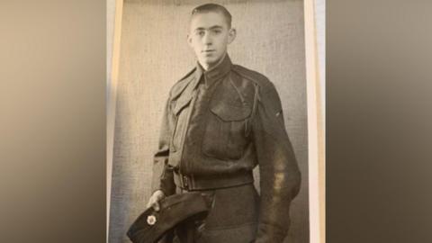 Ken Hobbs as a young man in uniform, in a black and white image.