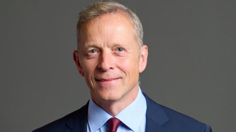 An official portrait of Matt Rodda, who is wearing a dark blue jacket, light blue shirt and maroon tie 