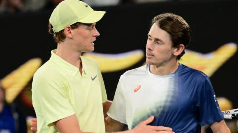 Jannik Sinner hugs Alex de Minaur after their Australian Open quarter-final