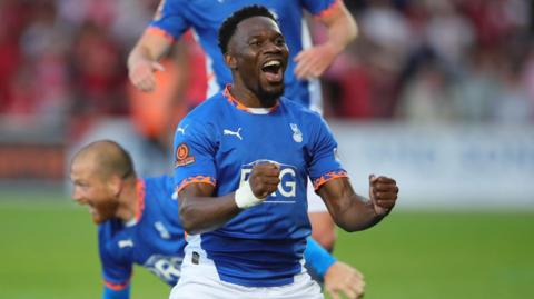 Mike Fondop celebrating as Oldham beat York in the National League play-off 