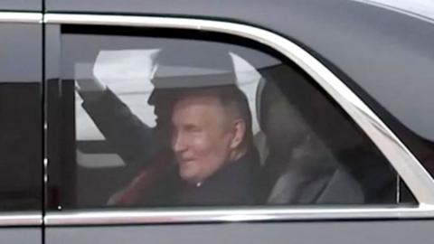 Vladimir Putin in the back of a limousine