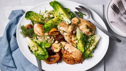 A platter with a carved roast chicken, grilled lettuce and caramelised lemons