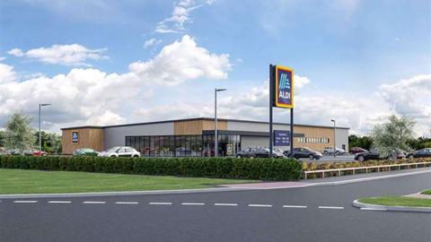 A computer generated image of the proposed Aldi store on West Road in Bourne a large single storey building in grey with wood cladding on the corners