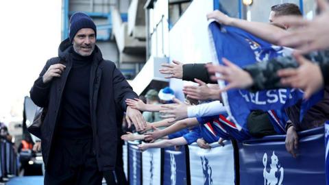 Enzo Maresca interacts with fans as he arrives at the stadium prior to the Premier League match between Chelsea and Everton