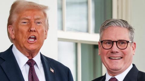 Trump in dark suit and red and blue tie with mouth open and Starmer in similar suit with same tie and glasses smiling