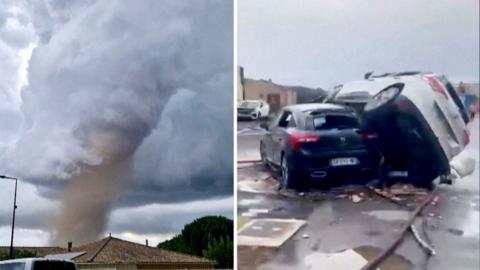 A tornado is seen spinning above a house in the clouds, with two cars on top of each other on the right.
