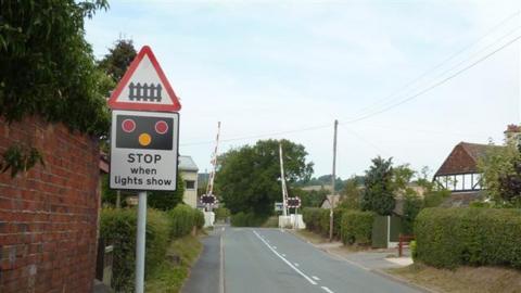 a train crossing from the view of a road