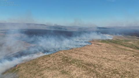 Smoke from a wildfire over the popular peak Pen y Fan in Bannau Brycheiniog 