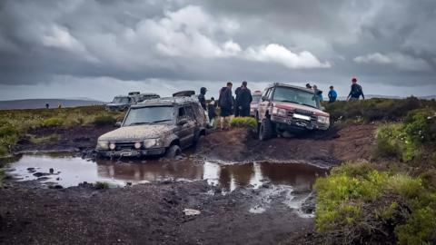 Two 4x4 vehicles are seen trapped in bogland