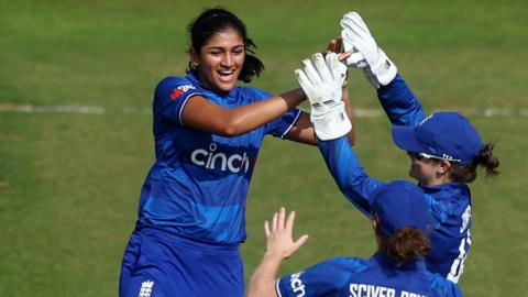 Mahika Gaur celebrates taking a wicket with Amy Jones