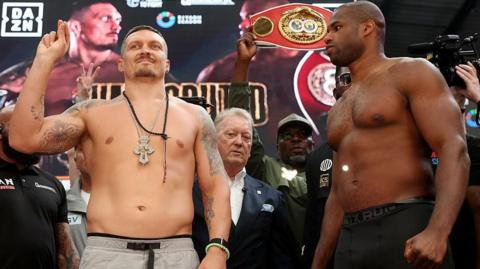 Oleksandr Usyk smirks as Daniel Dubois stares at him