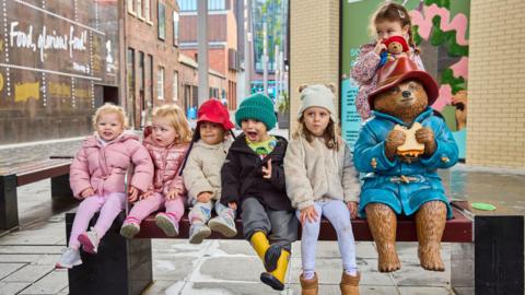 Paddington statues and children in Liverpool.