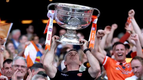 Armagh manager Kieran McGeeney lifts the Sam Maguire Cup after victory over Galway