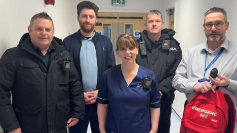 NHS Western Isles staff standing together in a hospital ward.