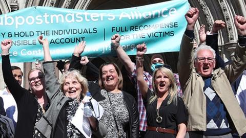 Lorraine Williams, centre left with glasses, and Noel Thomas celebrating outside Royal Courts of Justice in London