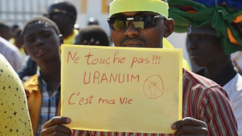 A Niger man holds a placard reading 'Don't touch!!! Uranium is my life' during a demonstration against French nuclear giant Areva.