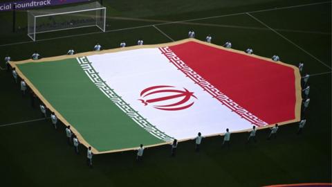 The Iran flag being displayed on the pitch prior to their World Cup against England