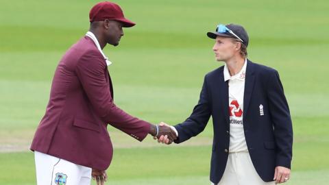West Indies' Jason Holder (left) and England's Joe Root (right) shake hands before the start of a Test