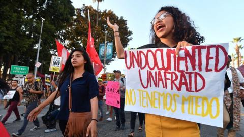 Young immigrants, activists and supporters of the DACA program march through downtown Los Angeles, California.