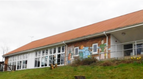 Exterior view of Brynhafren Community Primary School - a single storey building with drawings on the wall