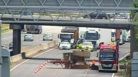Still camera image from a motorway collision involving a lorry and a bridge