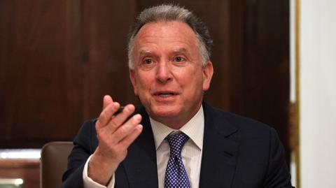 Steve Witkoff speaks and gestures with his right hand