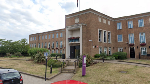 The Royal Borough of Windsor and Maidenhead council house, a mid-20th century, three storey building, with a small grassed area around it