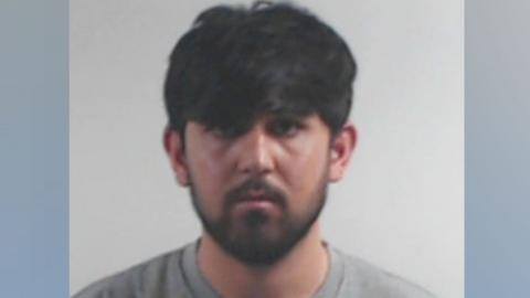 A police mugshot of a bearded Rapualla Ahmadze looking at the camera.