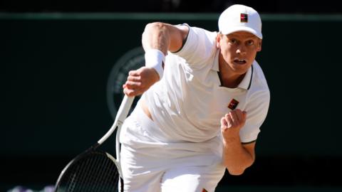 Jannik Sinner serves