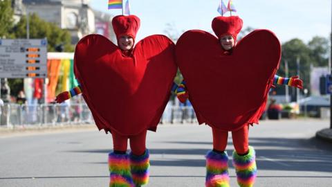 Two people dressed as hearts