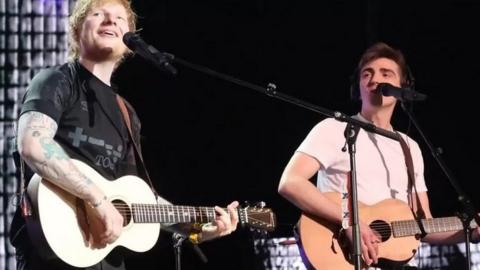 Ed Sheeran with Luke Gittins on stage at the O2 in London