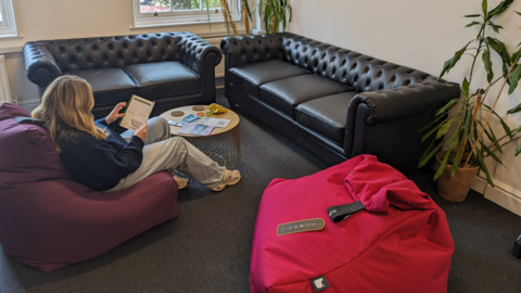 Woman sitting on bean bag in new shelter