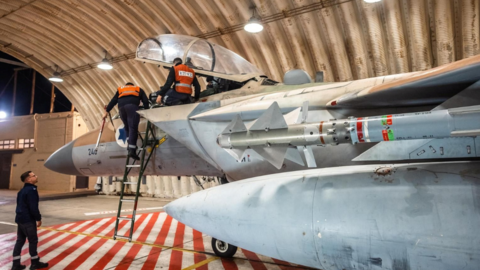 Crews work on an Israeli Air Force F-15 Eagle in a hangar, said to be following the interception mission of an Iranian drone and missile attack on Israel