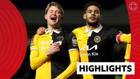 JJ McKiernan and Kyran Lofthouse celebrate in yellow and black Burton Albion kit
