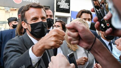 French President Emmanuel Macron (L) and his wife Brigitte Macron (C) salute people in Valence, France, 08 June 2021