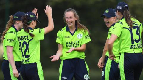 Ireland celebrate a wicket by Orla Prendergast