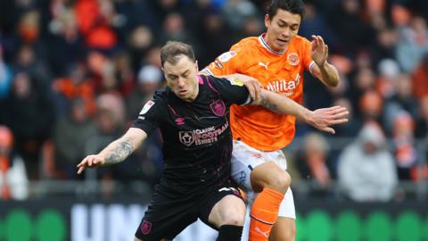 Burnley and Blackpool players fight for possession during their goalless draw