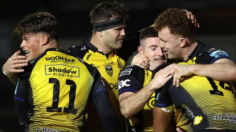 Dragons players celebrate victory over Ospreys
