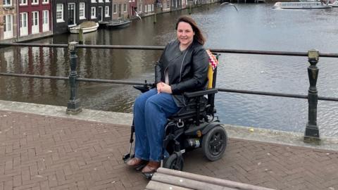 Sam Jennings on a bridge in her powerchair during trip to Amsterdam.