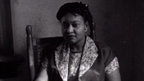 Mamie Till sits in a rocking chair