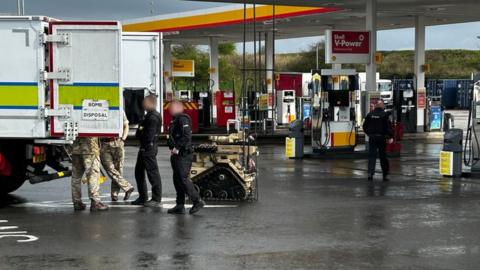 Police and bomb disposal experts at the garage on the A19