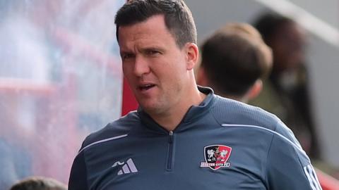 Exeter City manager Gary Caldwell in the dugout