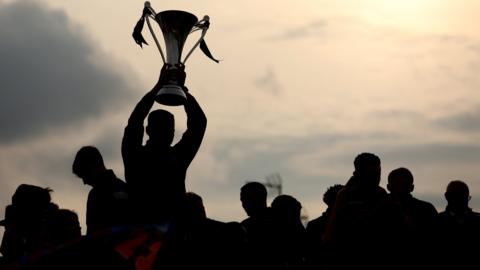 Wrexham players celebrate with the National League trophy