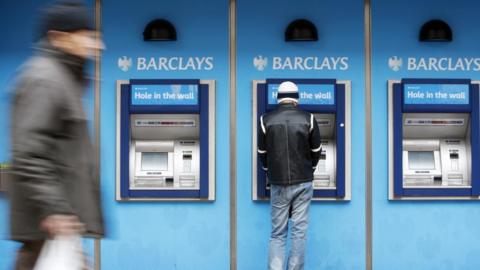 Person using a Barclays cashpoint