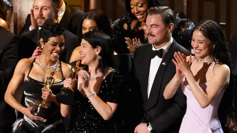 Leonardo Di Caprio joins co-stars of One Battle After Another on stage.