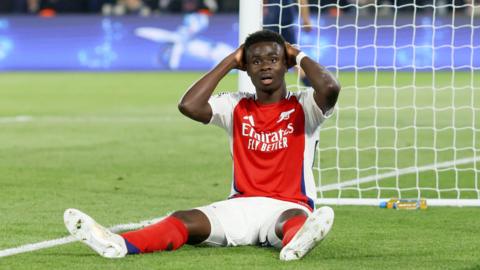 Saka holds his head in his hands