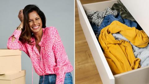 Dilly Carter smiling next to an open drawer full of clothes stuffed in randomly.