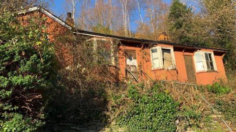 Exterior view of the orange-coloured prefabricated cottages