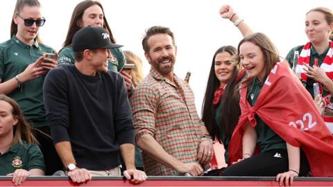 Ryan Reynolds, Co-Owner of Wrexham, and Rob McElhenney, Co-Owner of Wrexham, celebrate with players